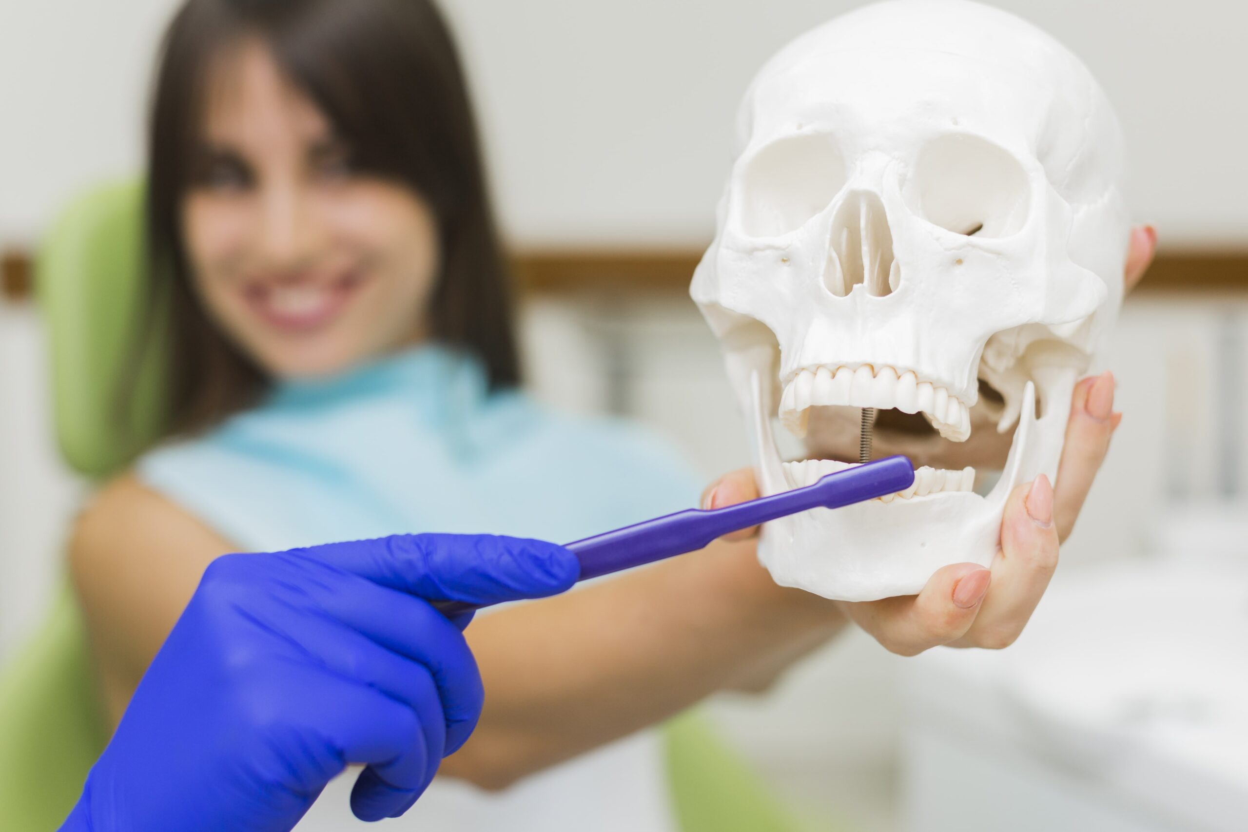 dentist-holding-skull-toothbrush-min Bone Grafting & Ridge Augmentation Near You in Kelowna